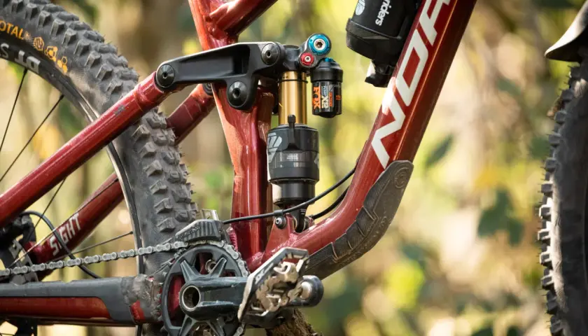 Close-up of a Norco Sight bike's rear suspension, featuring a Fox Float X2 shock. This detailed shot is perfect for a fox float x2 review.