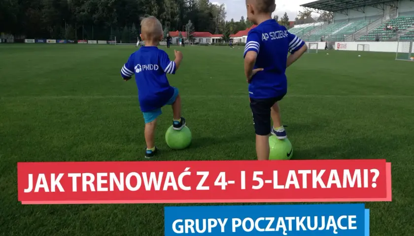 Dwóch chłopców w strojach piłkarskich na boisku, przygotowujących się do treningów piłki nożnej dla dzieci.