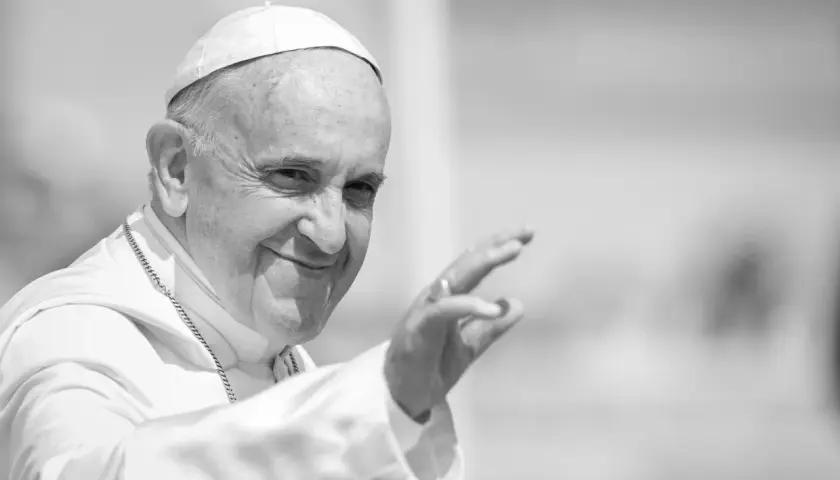 Papst Franziskus winkt lächelnd in die Menge.