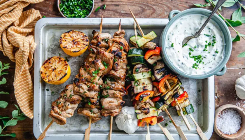 Grillad shish kebab med grönsaker, citron och en krämig dipp. Perfekt för en sommarkväll.