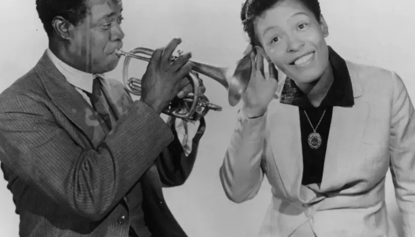 Louis Armstrong gra na trąbce, a Ella Fitzgerald słucha, zastanawiając się, co to scat.