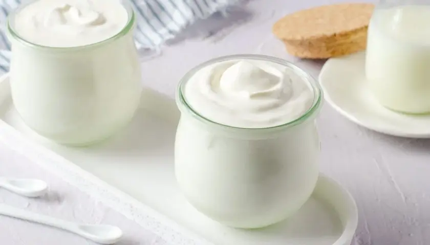 Dos frascos de yogur casero cremoso, listos para disfrutar. Aprende como hacer yogurt casero.