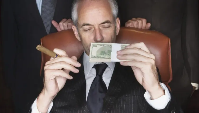 Mężczyzna w garniturze z cygarem w dłoni wącha stos banknotów. Sekret jak że 100 tys zrobić milion?