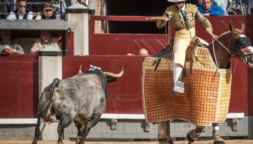 Joaquín Moreno Silva, un torero a caballo, se enfrenta a un toro en la arena.