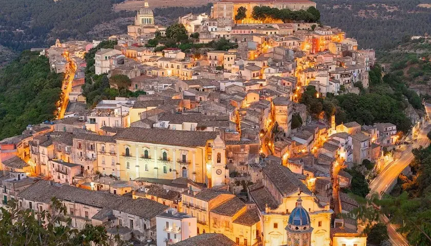 Illuminated Ragusa, Sicily, glows at dusk. Explore its Baroque architecture and charming streets for unforgettable things to do in Ragusa.