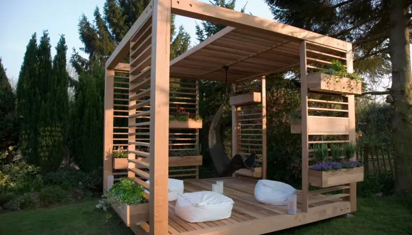 Moderne Holzkonstruktion mit integrierten Pflanzkästen und Hängesessel. Tolle Garten Pavillon Ideen für Entspannung.