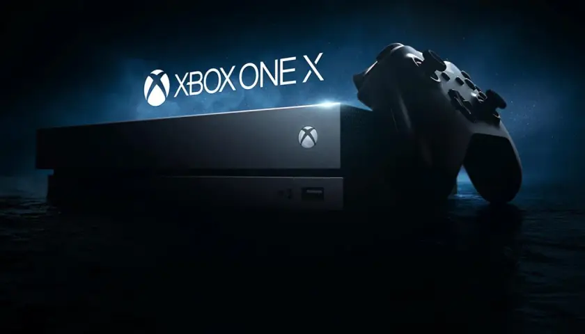 Konsola Xbox One X i kontroler na ciemnym tle. Gotowi na epicką rozgrywkę?