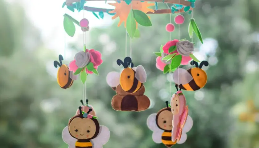 Niedliche Bienen und Blumen aus Filz, ein tolles Beispiel für **handy basteln** für ein Kinderzimmer.