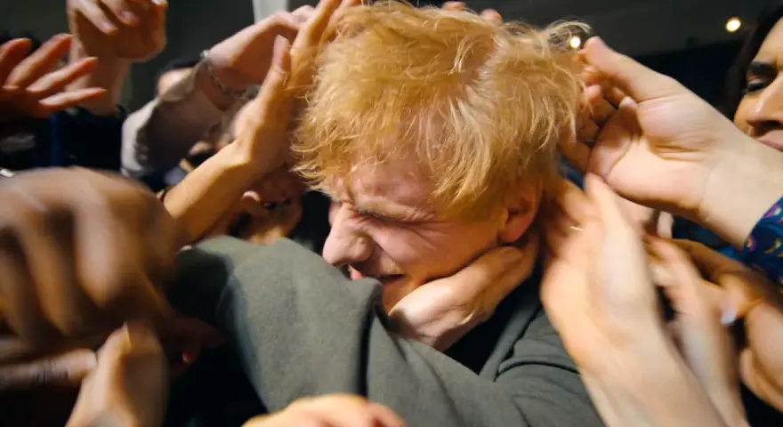 Ed Sheeran, mój azizam, otoczony przez tłum dłoni, które chcą go dotknąć.