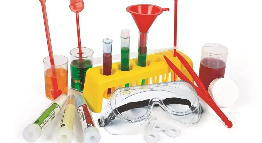 Zestaw do doświadczeń chemicznych dla klasy 7 w domu: probówki, zlewki, lejek, okulary ochronne i inne akcesoria do bezpiecznych eksperymentów.