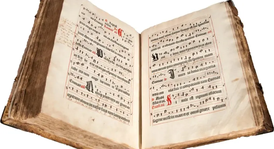 An ancient illuminated manuscript, its pages filled with musical notation and text, evokes the divine hours.