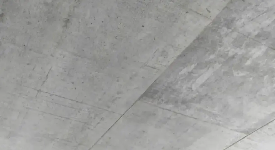 Surowy, betonowy sufit z widocznymi liniami szalunku. Betonowy sufit inspiracje dla minimalistycznych wnętrz.