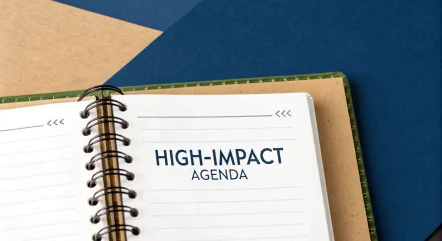 A notebook open to a page titled "HIGH-IMPACT AGENDA," ready for a productive board meeting.
