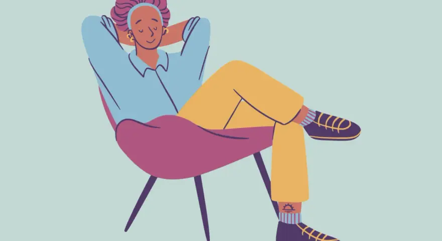 A person relaxes in a chair, hands behind their head, demonstrating how to decompress.