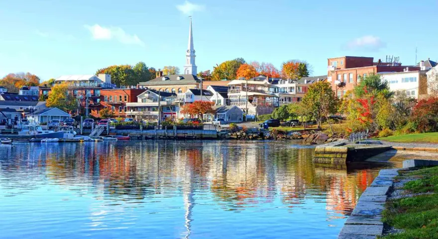 A charming New England harbor town with colorful autumn foliage, perfect for weekend getaways.
