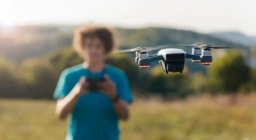 A person controls a drone, unaware of the potential penalty for flying a drone without a license.