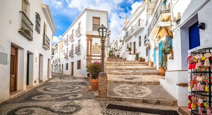 Calle empedrada con diseño de guijarros, casas blancas y escalinata. Un rincón perfecto para tu ruta Andalucía 7 días.