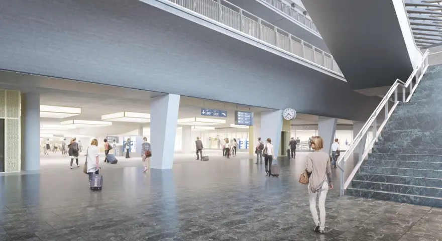 Modern, spacious interior of the Lucerne train station with travelers and digital departure boards.