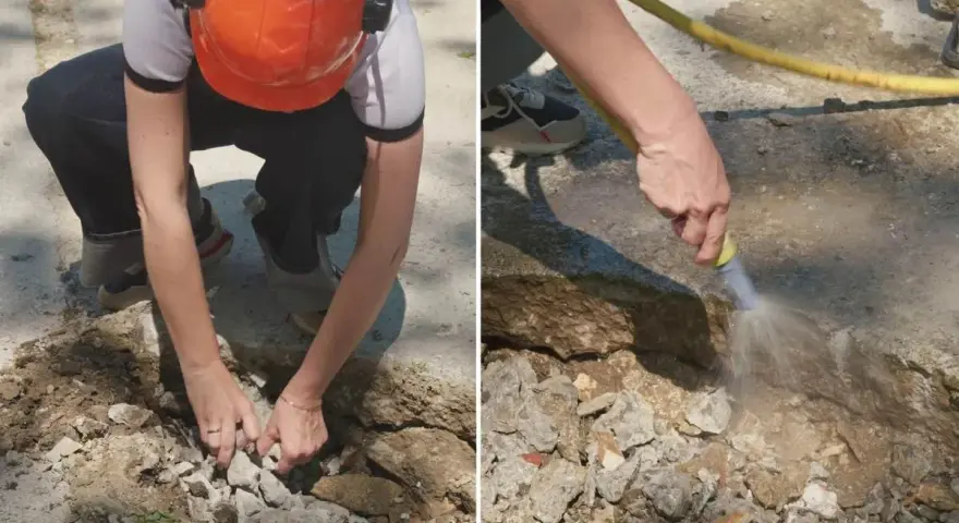 Preparando el área para reparar suelo de hormigón exterior. Se retiran escombros y se humedece la zona.