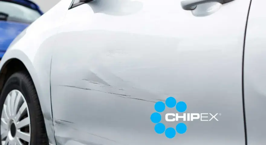 Scratches on a silver car door, with a CHIPEX logo. Can you buff out scratches like these?