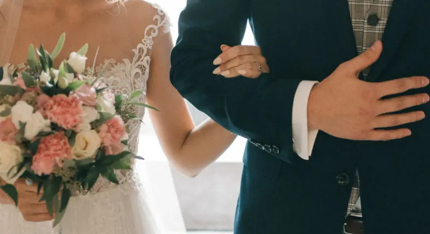 Para młoda idzie do ołtarza, trzymając bukiet. Wkrótce nauki przedmałżeńskie od ręki pomogą im w tej podróży.
