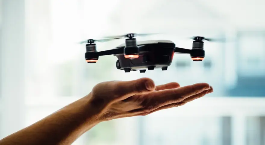 A drone hovers over an open hand, a visual metaphor for understanding Pennsylvania drone laws before takeoff.