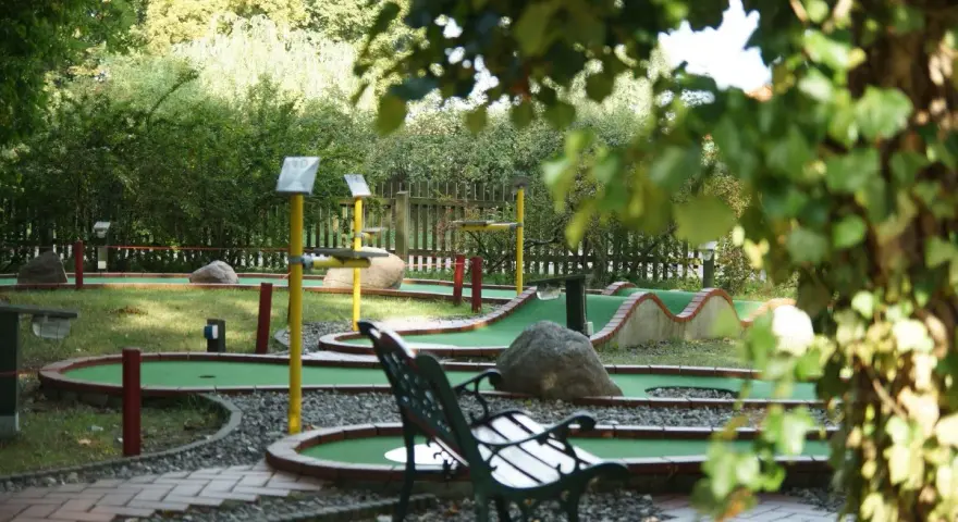 Minigolf Koserow: grüne Bahnen mit Hindernissen und Bänken laden zum Spiel ein.