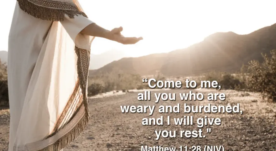 Jesus, in a flowing robe, extends an open hand in a desert landscape, offering rest as described in Matthew 11:28-30 meaning.