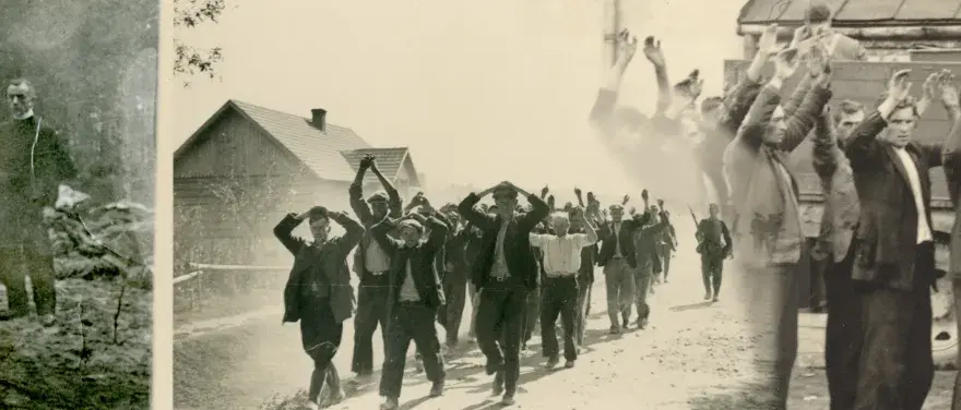 Zatrzymani mężczyźni z rękami w górze na drodze, być może w rejonie granica polsko-niemiecka 1939 Pomorze. W tle domy i żołnierz.