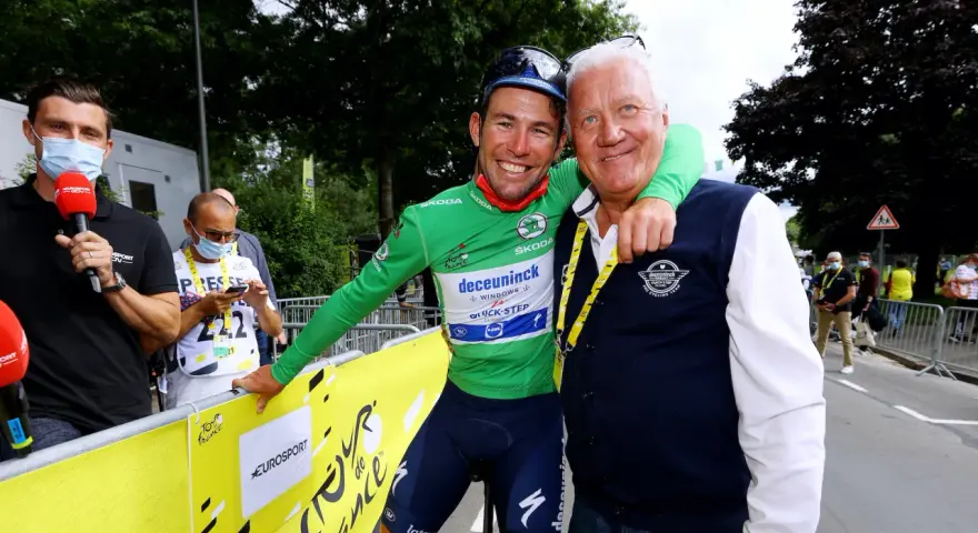 Cyclist in green jersey with Patrick Lefevere, both smiling.