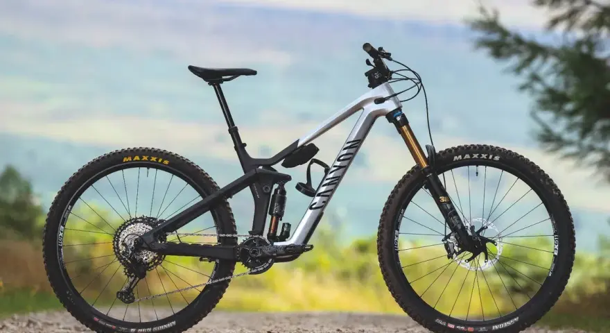 A silver Canyon enduro mountain bike with full suspension, ready to tackle any trail.