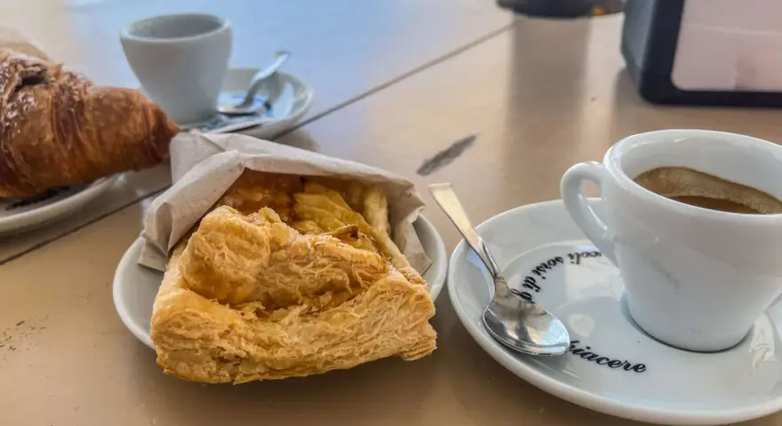 Ein Espresso und ein Croissant – so trinkt man in Italien! Dazu ein süßes Gebäck.