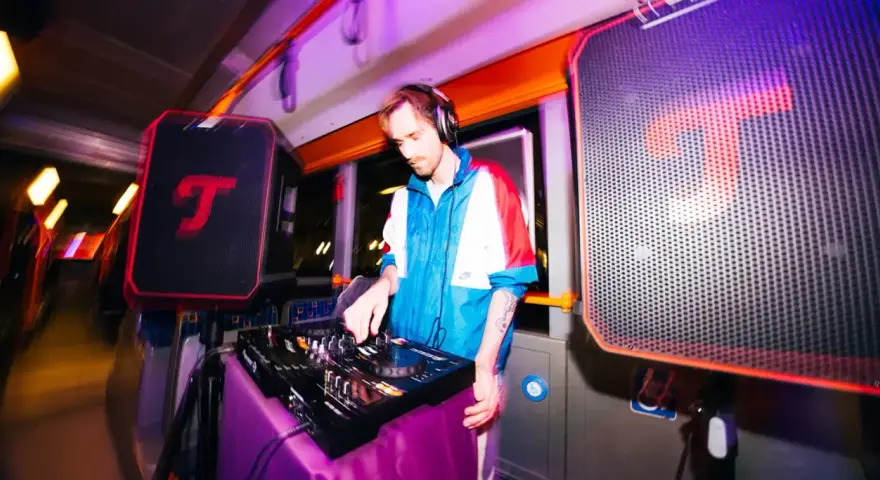DJ legt auf, während im Hintergrund eine **classical music playlist** läuft. Bunte Lichter und Lautsprecher schaffen eine einzigartige Atmosphäre.