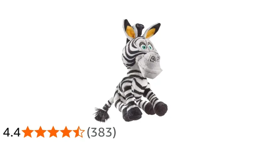 Pluszowa zebra z Madagaskaru, Marty, siedzi z szeroko otwartymi oczami i uśmiechem.