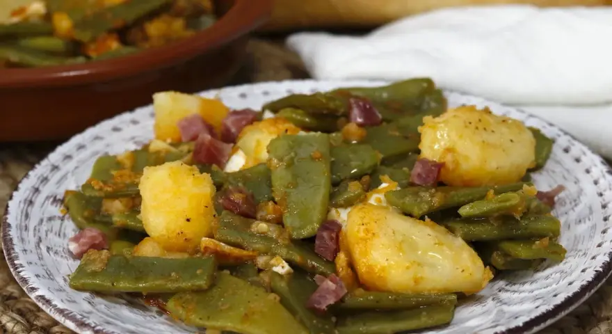 Plato de judías verdes con jamón y patatas, un clásico casero.