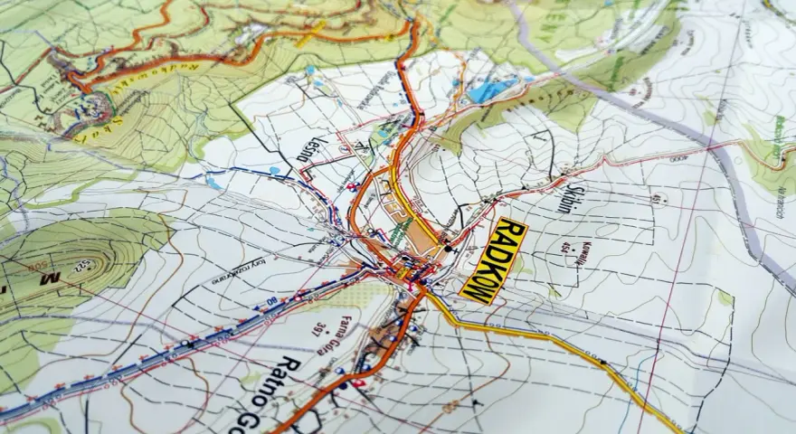 Mapa turystyczna z zaznaczonymi szlakami i miejscowościami, w tym Radkowem. Widoczne są **góry stołowe** i ukształtowanie terenu.