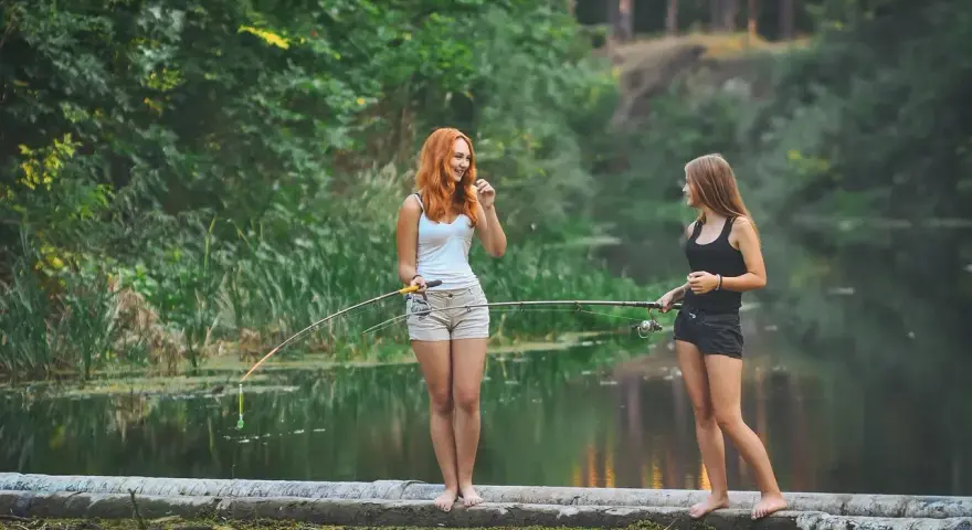 Dwie dziewczyny łowią ryby nad jeziorem wolickim.