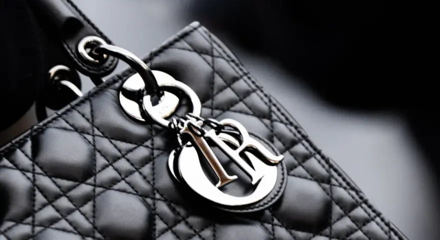 Elegancka, pikowana torebka Lady Dior w kolorze czarnym, z metalicznym logo Dior.