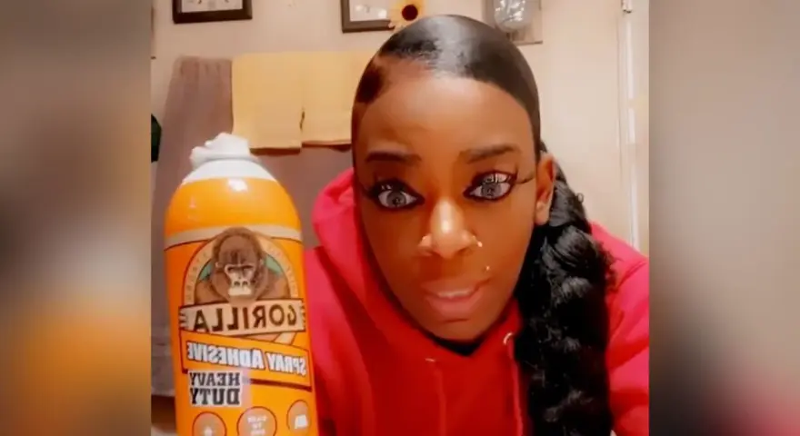 A woman holds a can of Gorilla Glue, wondering if Gorilla Glue works on plastic.