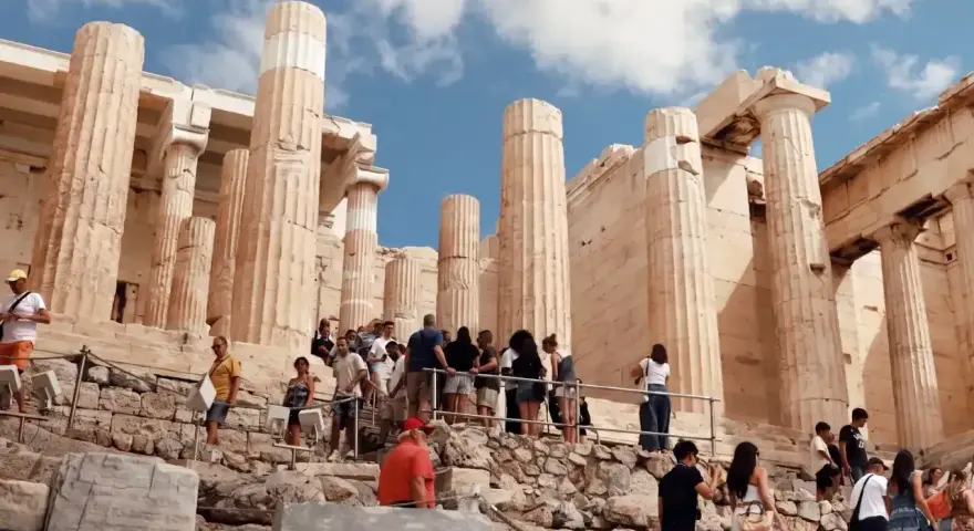 Tourists ascend the rocky path towards the Acropolis, a testament to how hard is the walk up to the Acropolis.