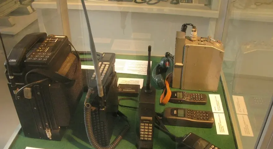 Pierwsza Nokia i inne zabytkowe telefony komórkowe, w tym modele NMT i radiotelefony, prezentowane na wystawie.