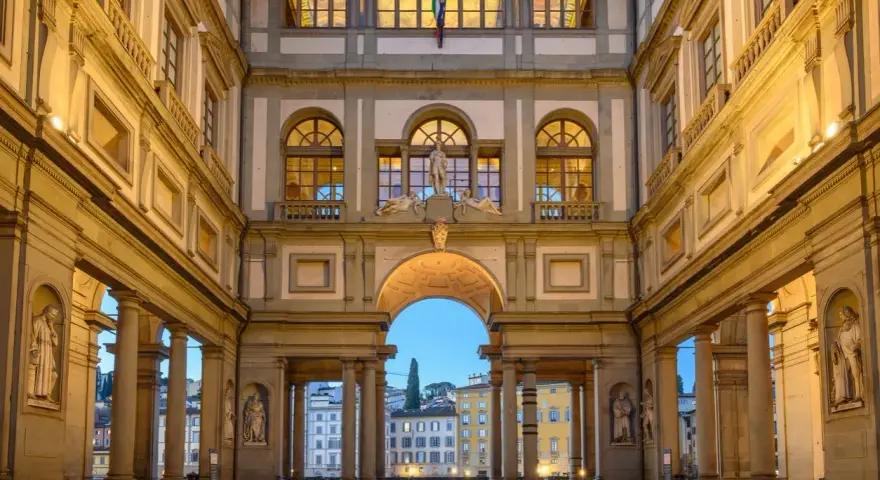 The Uffizi Gallery's courtyard at dusk, with its grand architecture and statues, offers a glimpse of Florence's artistic heritage, rivaling the Accademia.