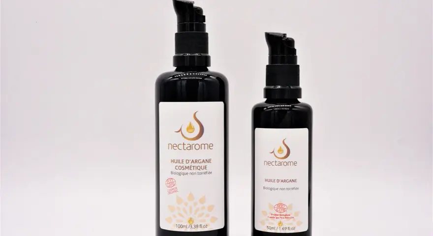 Deux flacons de Nectarome, l'un de 100ml, l'autre de 50ml, vantant les **huile d'argan bienfaits** cosmétiques biologiques.