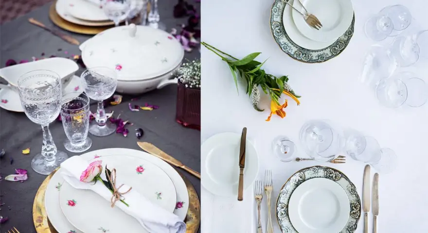Vackert dukat bord med vita rosa tallrikar, glas och blommor. En romantisk middagsbjudning väntar.
