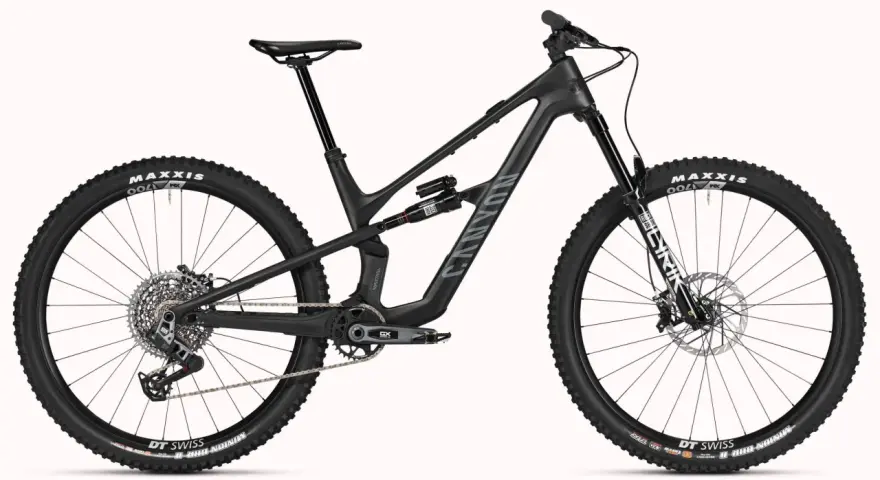 A black Canyon Spectral mountain bike, showcasing a mullet setup with a larger 29er front wheel and a smaller rear wheel, ready for any trail.