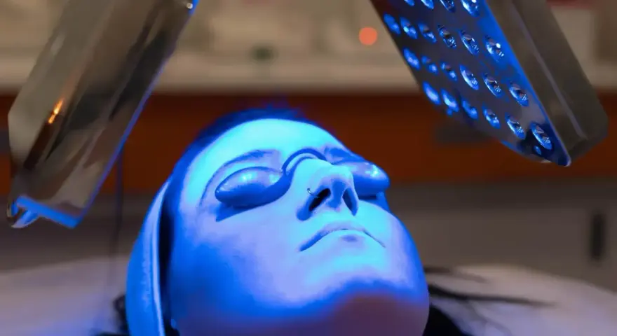 Woman receiving blue light therapy, exploring the blue light benefits for skin.