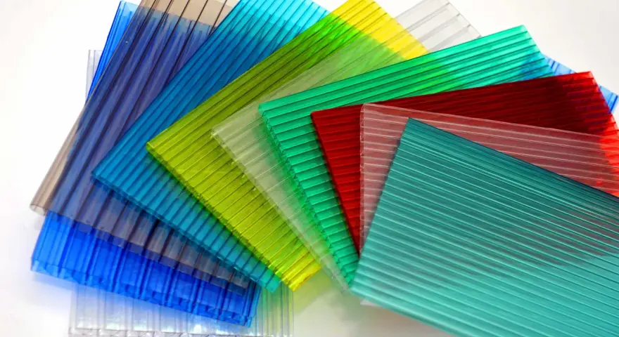 Sheets of colorful, ribbed polycarbonate, showcasing their versatility and potential for polycarbonate sustainability in various applications.