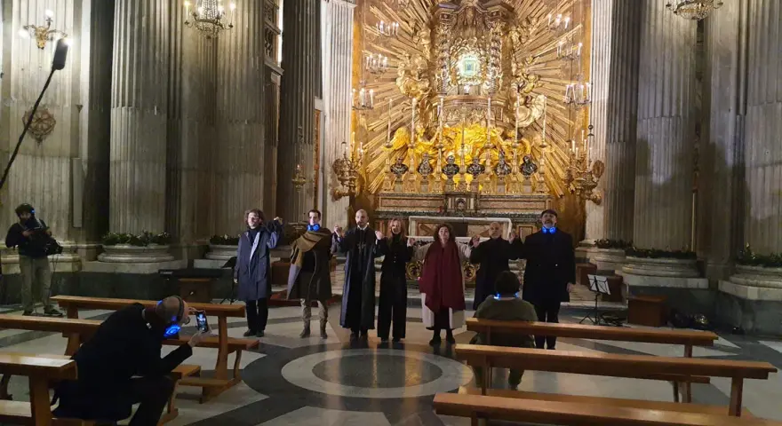 A group of people in a church, some holding hands, with a large golden altar in the background.