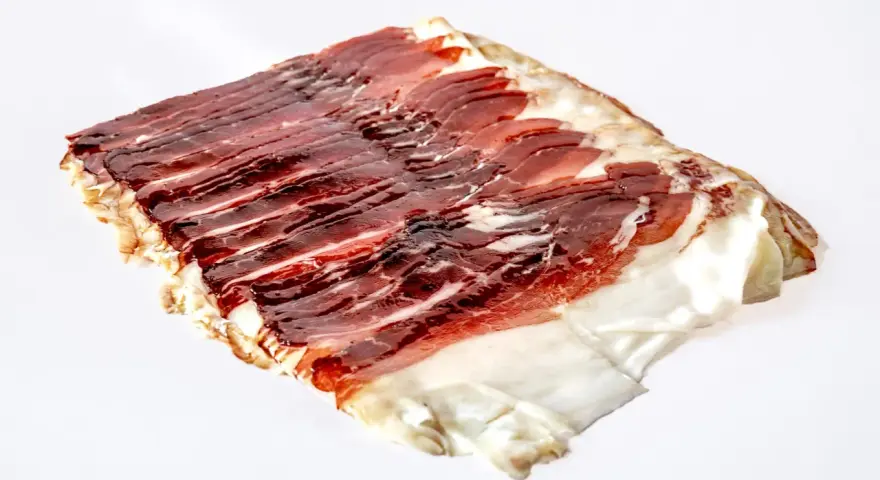 Dünn geschnittener, aromatischer Schinken vom Angler Sattelschwein. Das Fleisch ist dunkelrot mit feinen Fettäderchen und einem weißen Fettrand.
