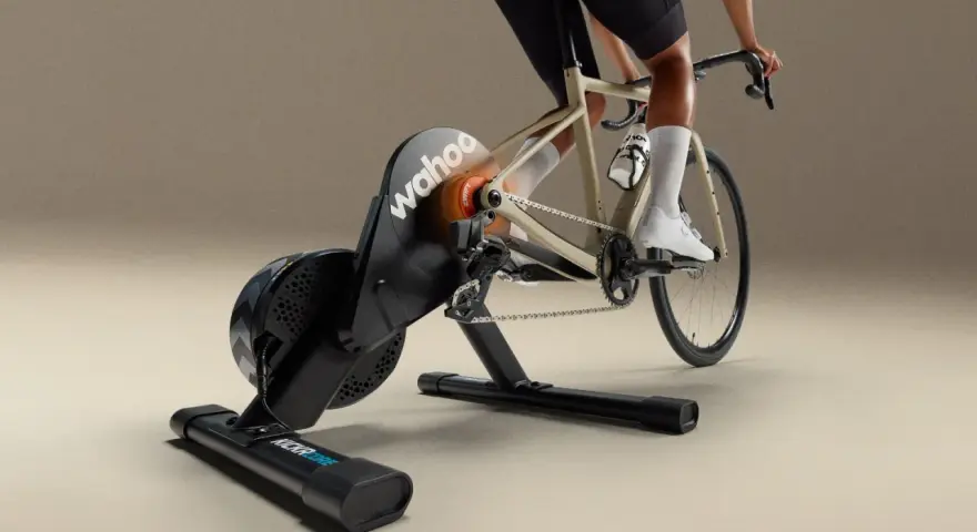 A cyclist rides indoors on a Wahoo Kickr Core 2 trainer, simulating an outdoor ride with realistic resistance.